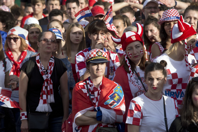 Supporters of the Croatian national soccer team look dejected watching the match in central Zagreb, Sunday, July 15, 2018. (AP)