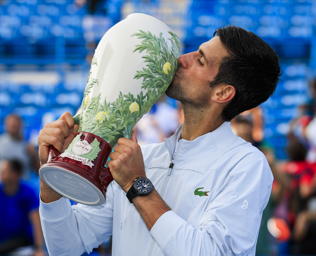 Novak Djokovic of Serbia kisses the winner`s trophy after defeating Roger Federer of Switzerland in their final match in the Western & Southern Open tennis tournament at the Lindner Family Tennis Center in Mason, Ohio, USA, on Aug. 19. (EPA-Yonhap)