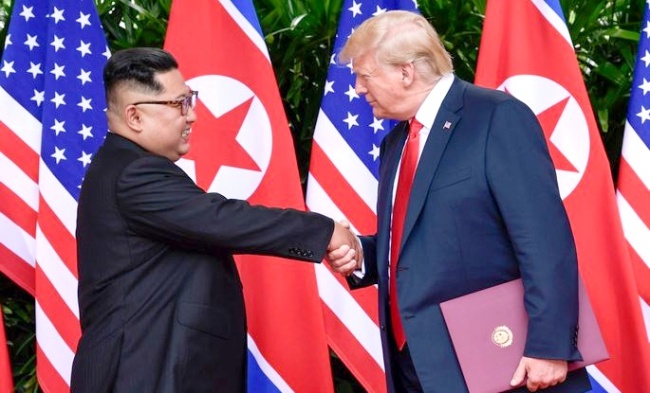 North Korean leader Kim Jong-un (left) shakes hands with US President Donald Trump in Singapore on June 12. (Yonhap)