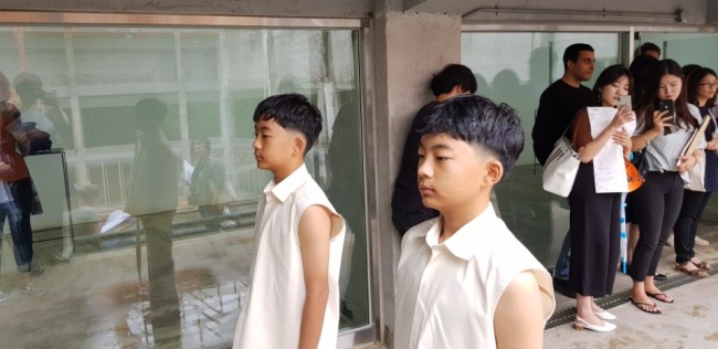 Young Korean twin brothers perform as part of a work by artist Tarik Kiswanson on Friday, at Palais De Tokyo’s exhibition at the 2018 Gwangju Biennale at the Gwangju Civic Center. (The Korea Herald/Shim Woo-hyun)
