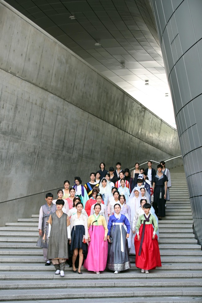 Models showcase 100 new hanbok designs made by student designers, at Dongdaemun Design Plaza on Monday. (Yonhap)