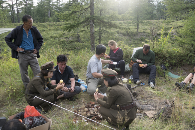 Shepherd’s team of travelers enjoy a meal with the North Korean guides. (Roger Shepherd)