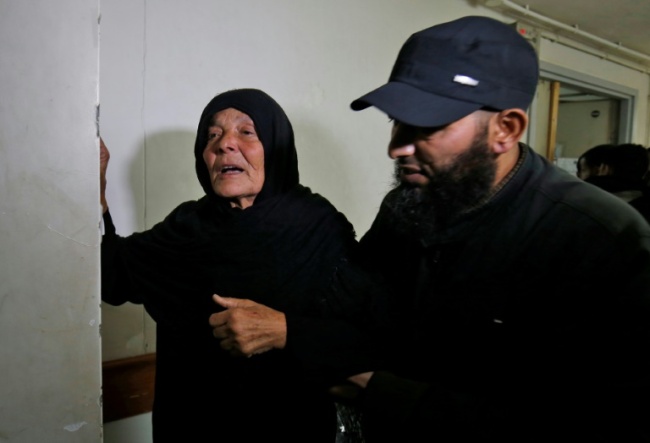 The mother of Nour Baraka, a commander for Hamas' armed wing, the Ezzedine al-Qassam Brigades who was killed during an Israeli operation on Khan Younis in the Gaza Strip, reacts at a hospital morgue where his body was transported November 11, 2018 (AFP)