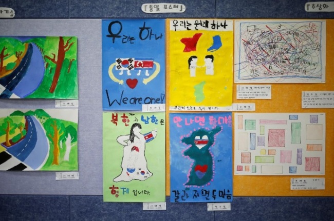 Posters bearing messages, wishing unification between the two Koreas, hang on a wall at the Daesungdong Elementary School, a school inside the demilitarised zone separating the two Koreas, in Paju, South Korea, November 22, 2016. (Reuters)