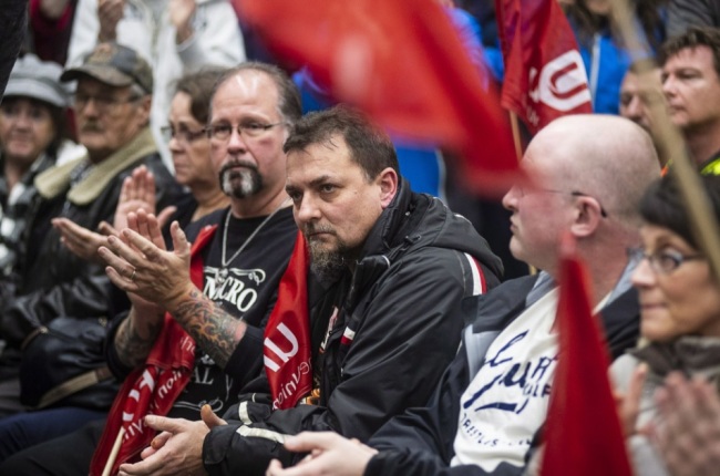 Workers of Oshawa`s General Motors car assembly plant, listen to Jerry Dias, president of UNIFOR, the union representing the workers, at the union headquarters in Oshawa, Ont. on Monday, Nov. 26, 2018. (AP)
