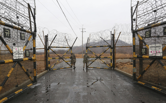 South Korean army soldiers open a military gate to enter inside the Demilitarized Zone (DMZ) in the central section of the inter-Korean border in Cheorwon. Yonhap