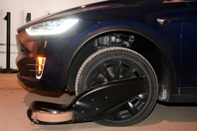 Cars are fitted with tracking wheels which stabilize the vehicle on a track allowing them to travel at high speed through a tunnel (AFP)