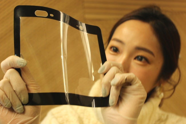 A researcher displays polyimide film developed by SK Innovation. (SK Innovation)