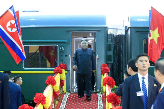 In this photo provided by Vietnam News Agency, Kim (center) arrives at Dong Dang railway station in Lang Son Province, Vietnam, Tuesday. (Xinhua-Yonhap)