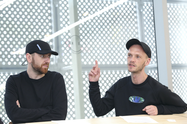 Designers Ben Cottrell (left) and Matthew Dainty, who run London-based menswear label Cottweiler, speak during an interview with The Korea Herald at Dongdaemun Design Plaza in central Seoul on Thursday. (Seoul Design Foundation)