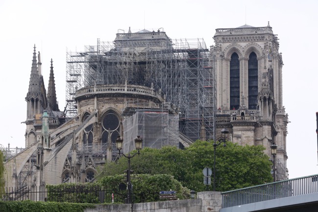 The Notre Dame Cathedral in Paris is still standing despite major damage caused by a giant fire 16 April 2019. French President Emmanuel Macron vowed to rebuild the 13th century building that welcomes tens of millions of worshippers and tourists per year. (Yonhap)