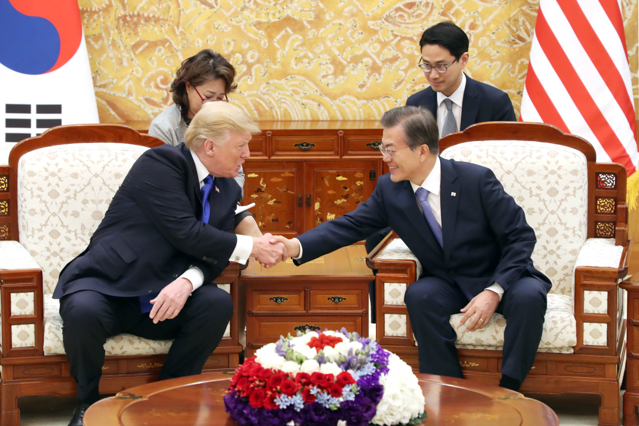 President Moon Jae-in and US President Donald Trump shake hands during their summit meeting in Seoul in November 2017. Yonhap