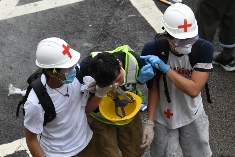 A protester is helped by medical volunteers after being hit by police tear gas -- officers were also hurt and health authorities said more than 70 people in total were injured, local broadcaster RTHK reported. (AFP)