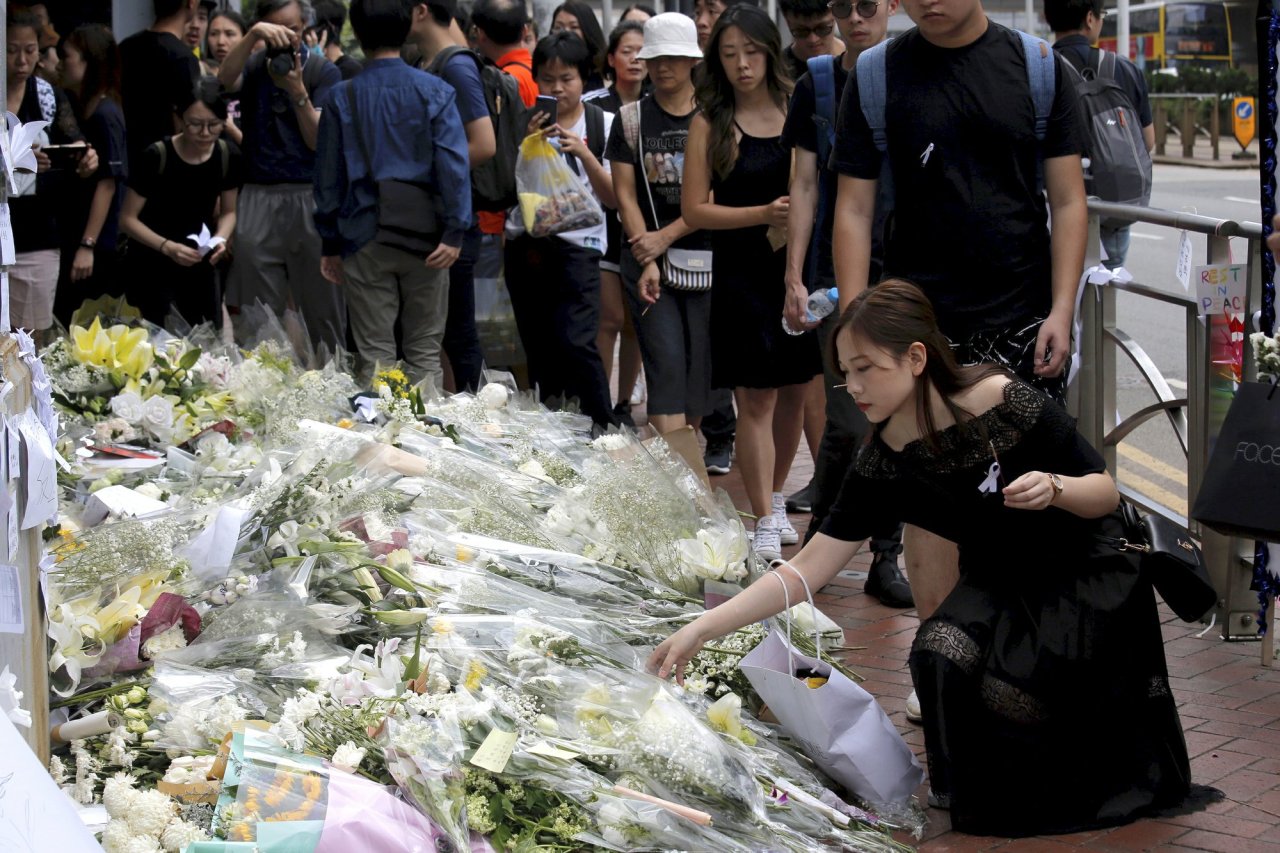 Mourners stop by a makeshift memorial, to lay flowers and pray for a man who fell to his death Saturday after hanging a protest banner against an extradition bill in Hong Kong Sunday, June 16, 2019. Tens of thousands of Hong Kong residents, mostly in black, have jammed the city’s streets Sunday to protest the government’s handling of a proposed extradition bill. (AP)