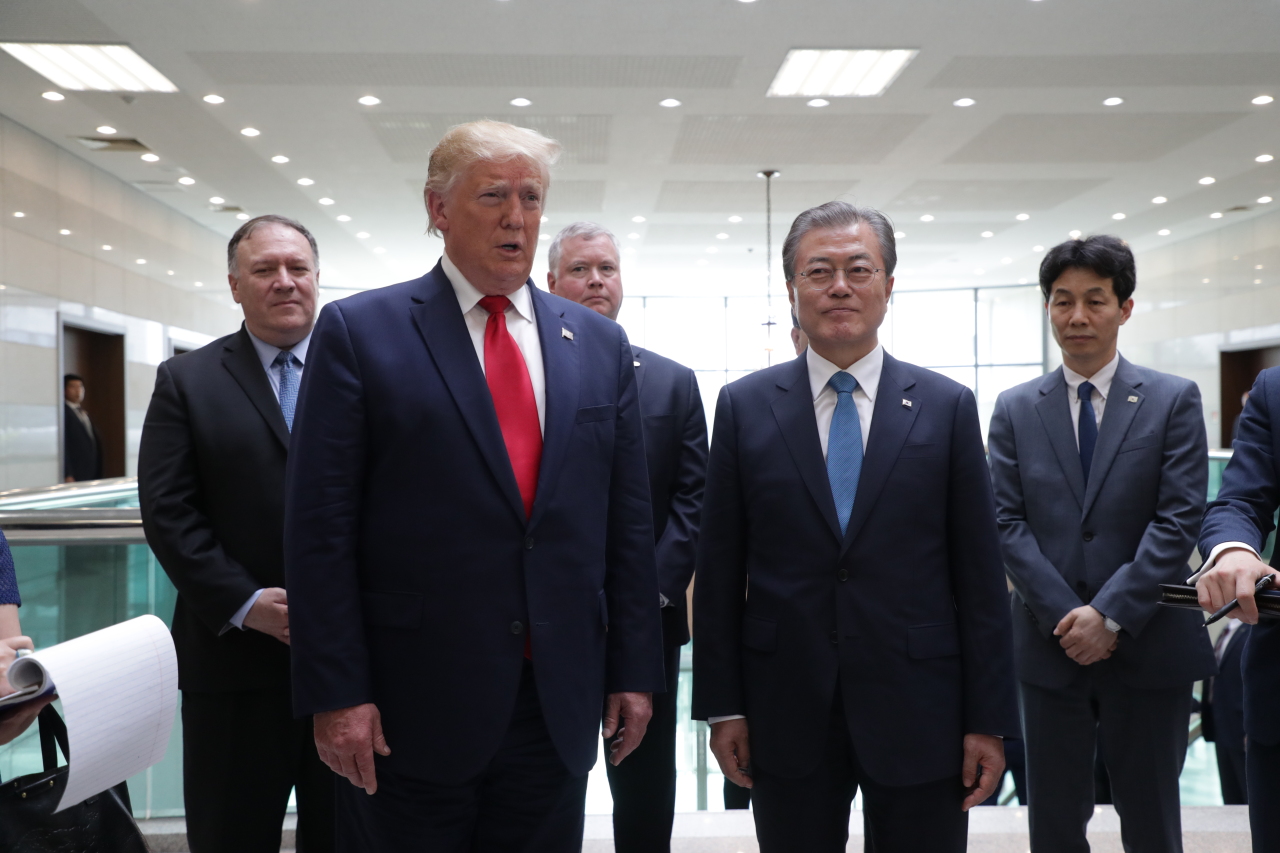 US President Trump briefs to reporters after holding a meeting with North Korean leader Kim at the truce village of Panmunjom. (Yonhap)