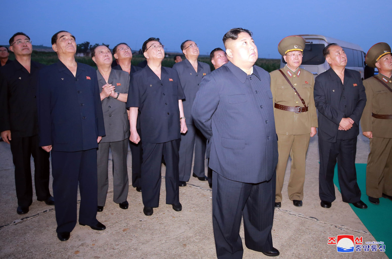 North Korean leader Kim Jong-un watches the launch of a newly developed guided weapon on Tuesday. Yonhap