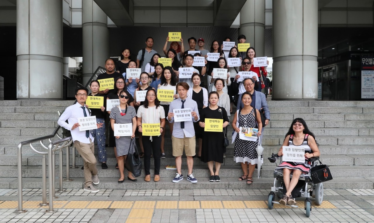 Adoptee rights activists and allies gather in support of Adam Crapser (front, center) at the Seoul Central District Court on Tuesday after the first hearing in Crapser’s lawsuit. (Photo courtesy of Jes Eriksen)
