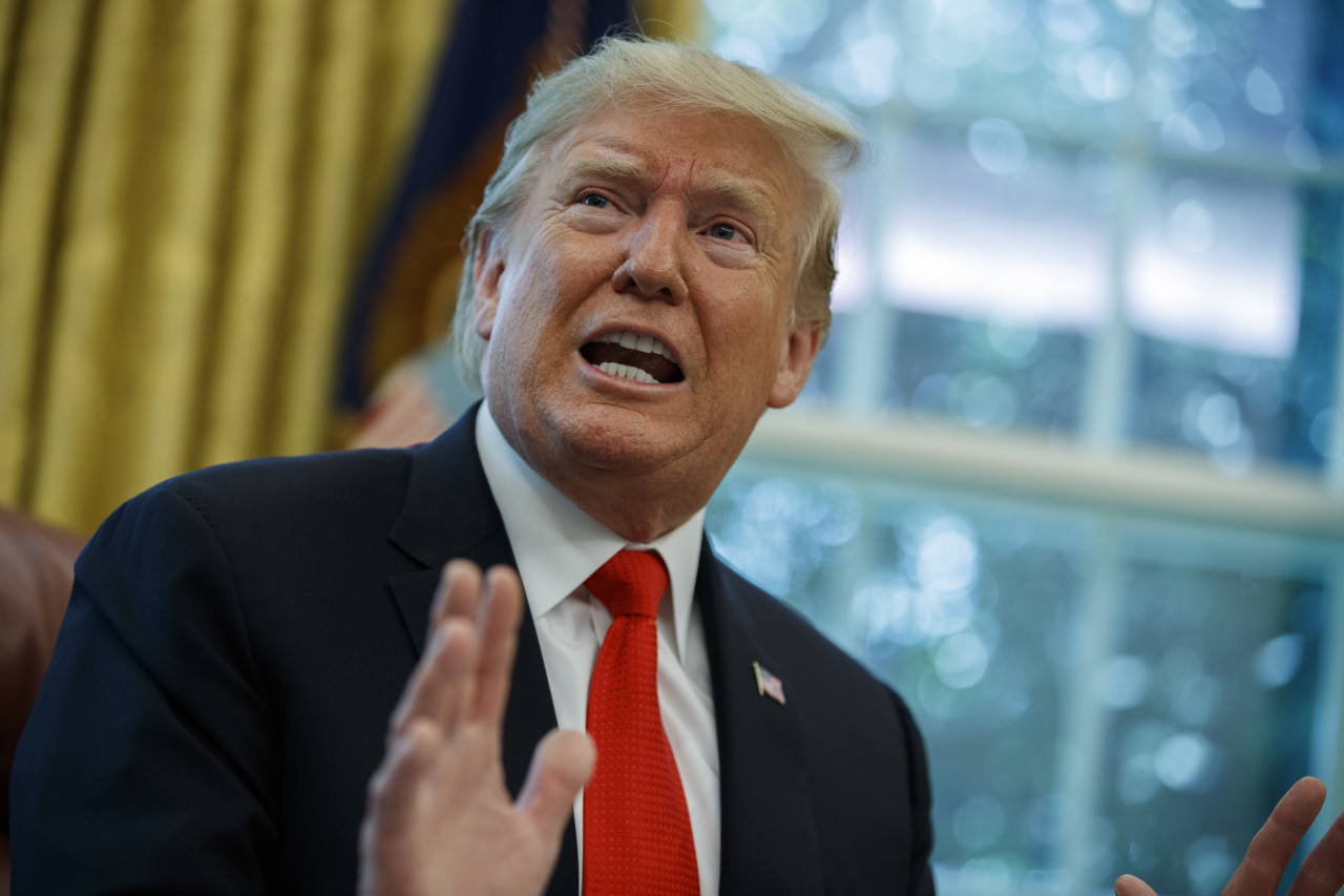 President Donald Trump talks with reporters after receiving a briefing on Hurricane Dorian in the Oval Office of the White House, Wednesday, in Washington. (AP-Yonhap)