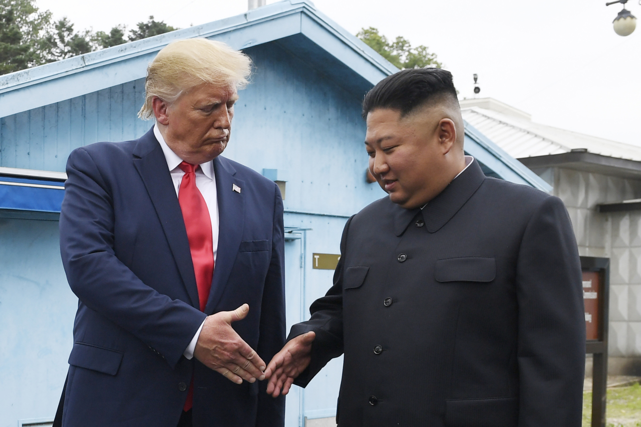 North Korean leader Kim Jong-un (right) and US President Donald Trump prepare to shake hands at the border village of Panmunjom in the Demilitarized Zone, South Korea. (AP-Yonhap)