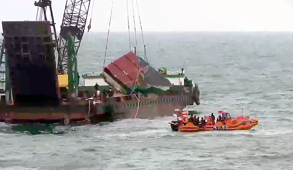 The rear part of the capsized boat is raised from the waters on Nov. 22. (Yonhap)