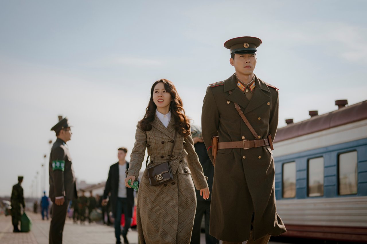 South Korean Yoon Se-ri, played by Son Ye-jin (left), and North Korean military official Ri Jung-hyuk, played by Hyun Bin, arrive in Pyongyang in a scene from “Crash Landing on You.” (Studio Dragon)