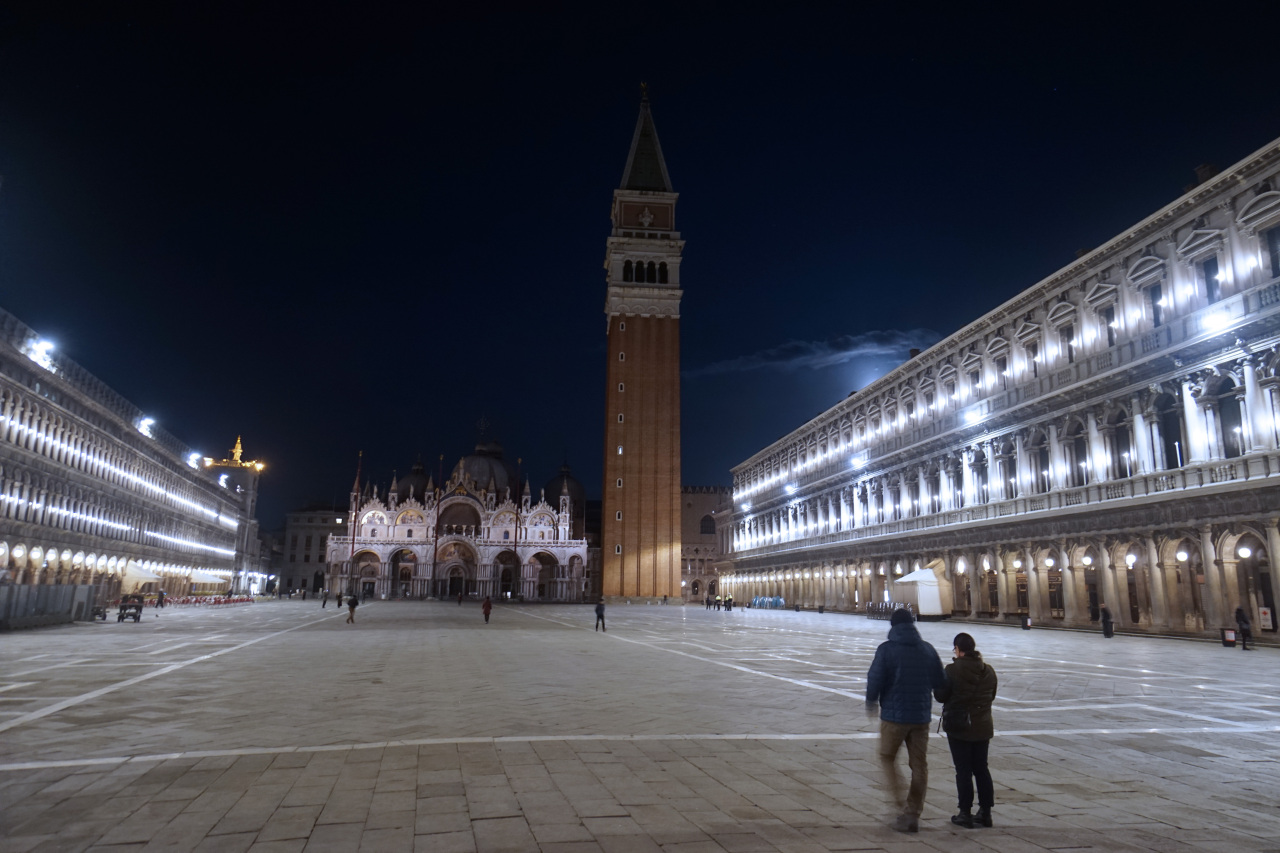 People walk in an almost empty St. Mark`s Square in Venice, Italy, earlier this month. (AP-Yonhap)
