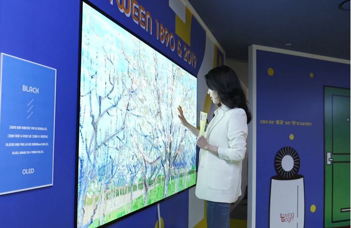 A high-end TV is showcased at a gallery in downtown Seoul in April 2019 in a collaboration between tech and art under the theme “Meet Vincent van Gogh.” Korean tech firms’ marketing, buoyed by a series of sports events, will likely be vitalized for up to 20 months between 2021 and 2022. (LG Electronics)