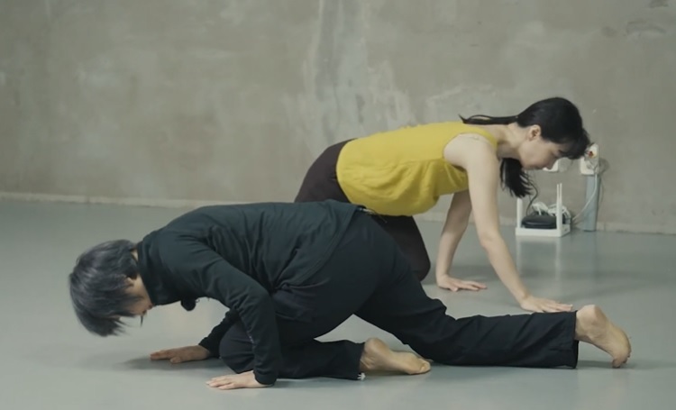 Nam Jeong-ho (front), artistic director of KNCDC, and dancer Kim Young-ran demonstrate crawling like an infant during the first episode of “Flexible Day.” (602 STUDIO/KNCDC)