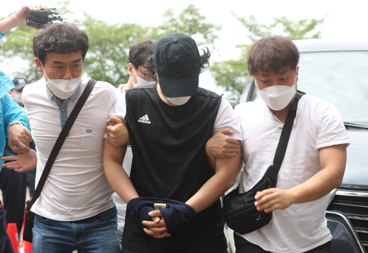 South Chungcheong Police arrest a man on charges of abusing his nine-year-old stepdaughter, Saturday. (Yonhap)