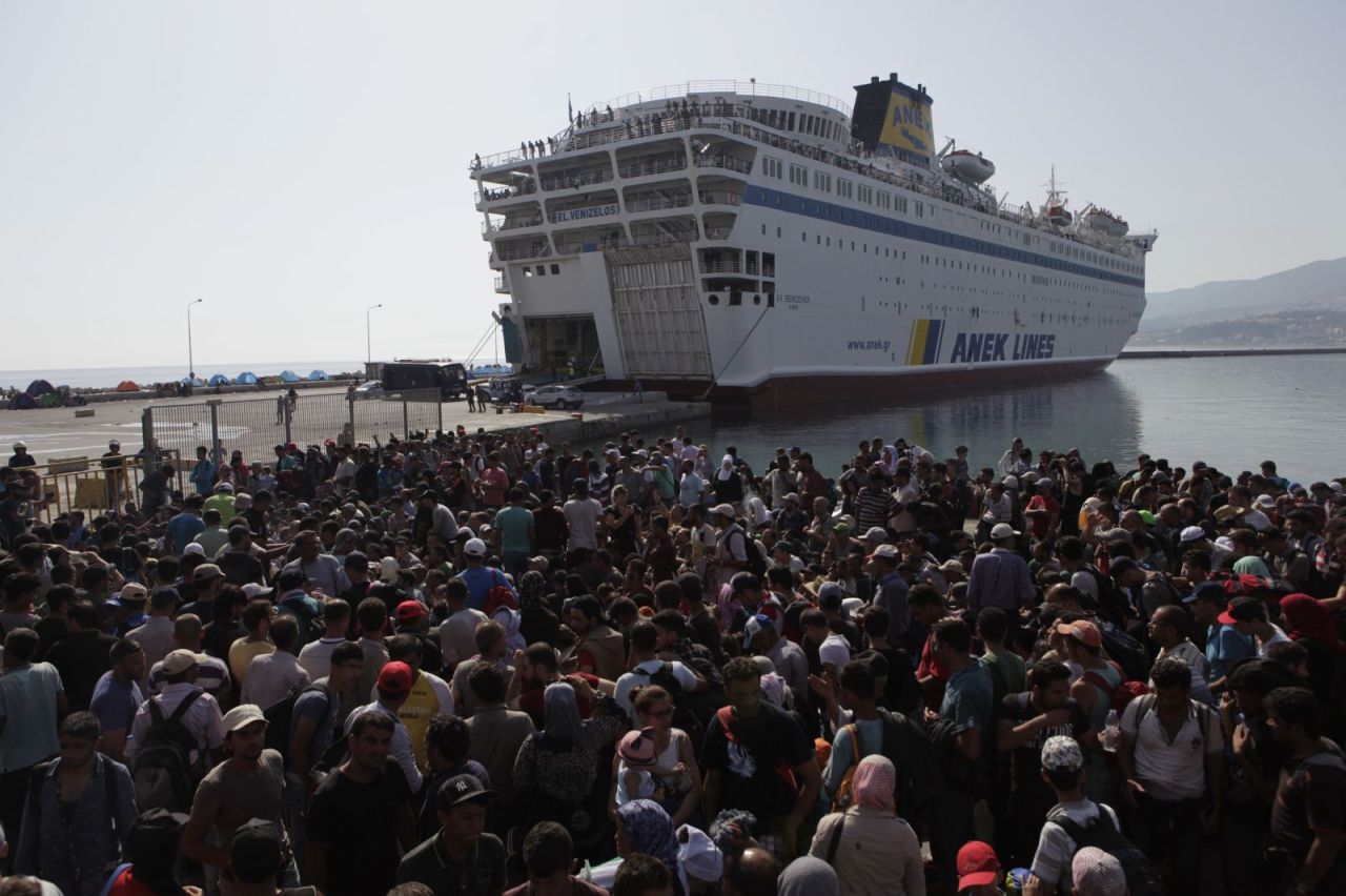 Syrian refugees on the Greek island of Lesbos ‎await boarding to head to the mainland. The Greek government has decided to build a 2.7-kilometer netted barrier off the island to deter migrants this year. (Courtsey of Harry Chun)