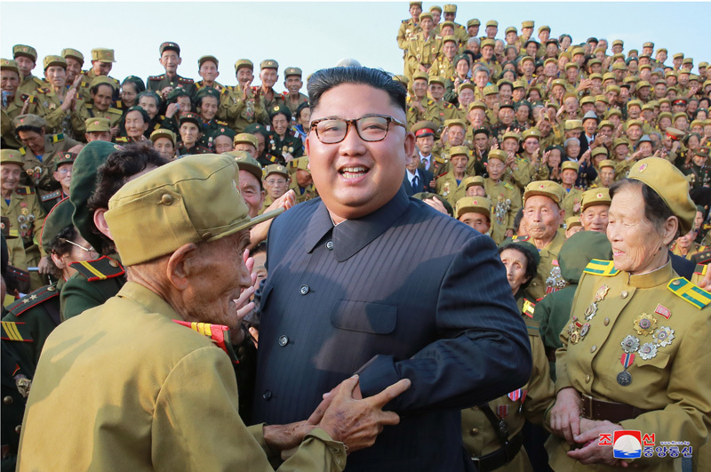 North Korean leader Kim Jong-un greets war veterans in this photo released by the North's Korean Central News Agency on July 26, 2018.