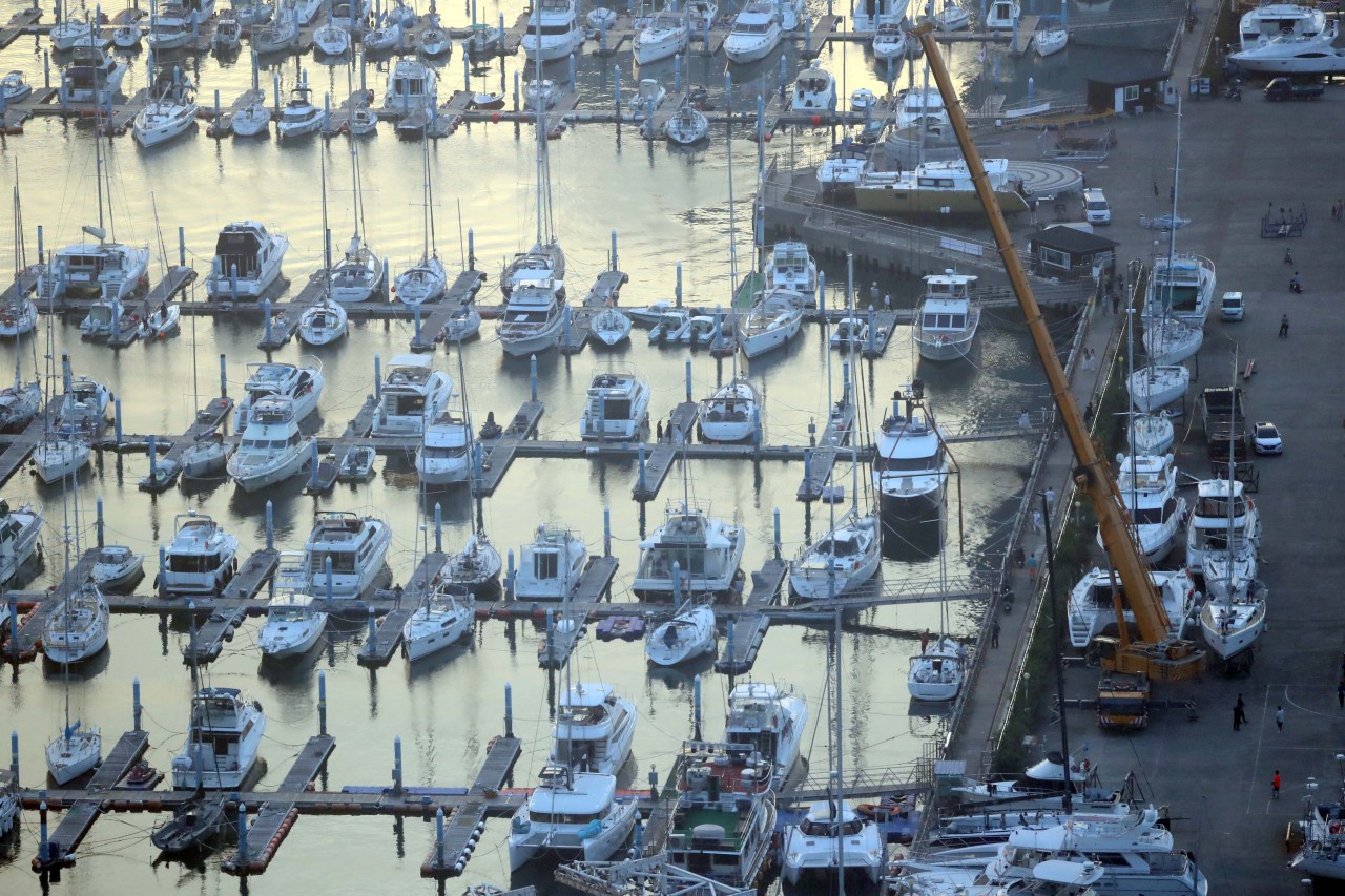 A crane moves yachts parked in Busan on Sunday ahead of Typhoon Maysak storming through the city from Wednesday to Thursday. (Yonhap)