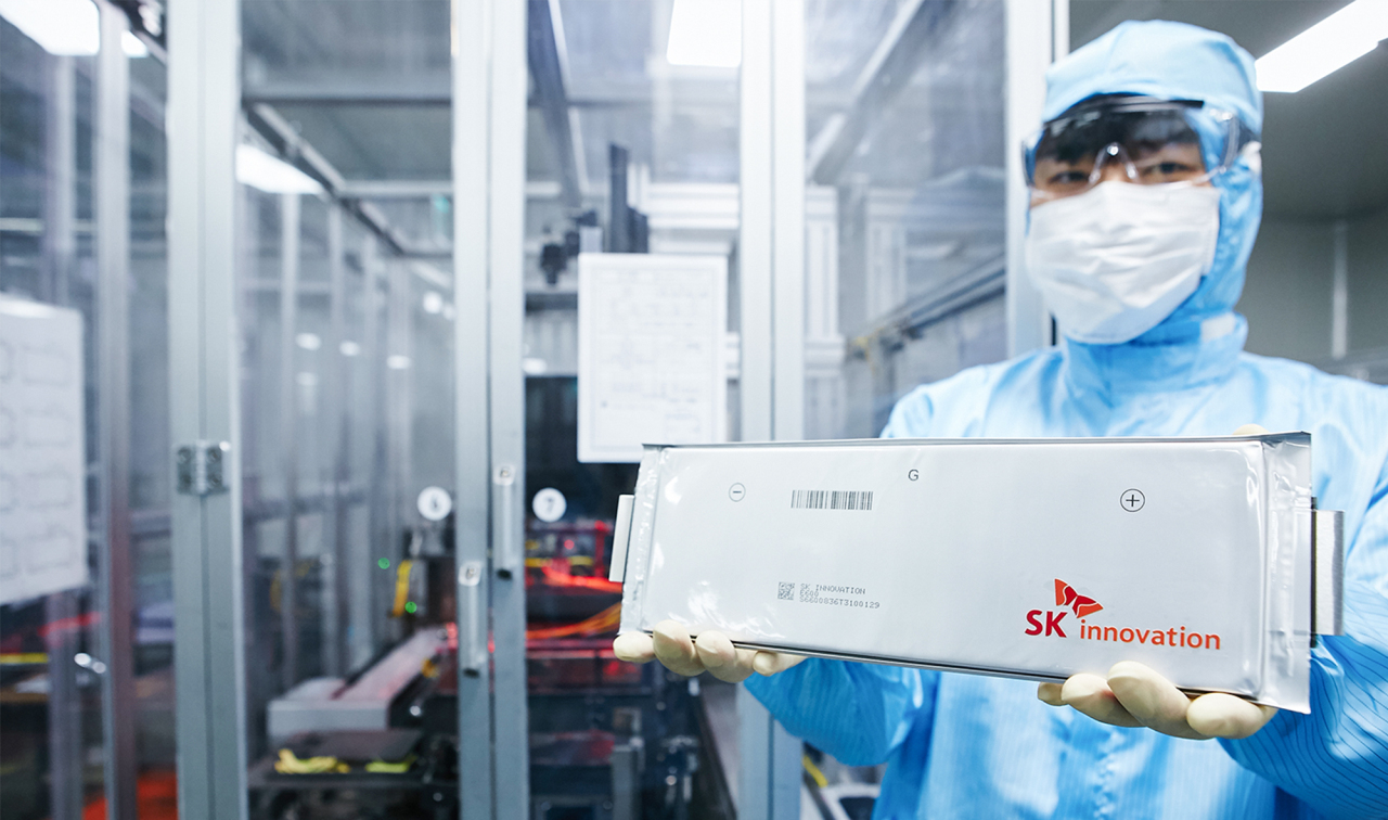 An SK Innovation official holds out the company’s battery cell. (SK Innovation)