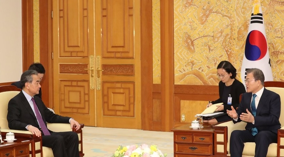 This file photo taken Dec. 5, 2019, shows South Korean President Moon Jae-in (R) talking with China's State Councilor Wang Yi at Cheong Wa Dae in Seoul. (Yonhap)