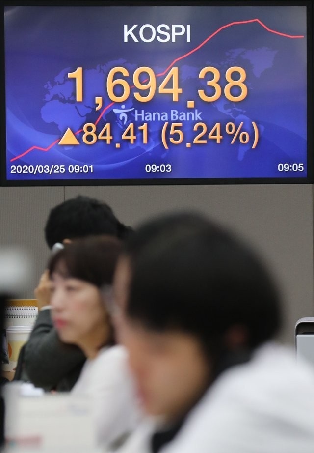 Currency dealers work in the dealing room of Hana Bank in Seoul on March 25, 2020. (Yonhap)