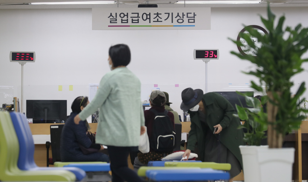 Visitors await their turn to apply for unemployment benefits at a regional office of the Ministry of Employment and Labor in Seoul in October. (Yonhap)