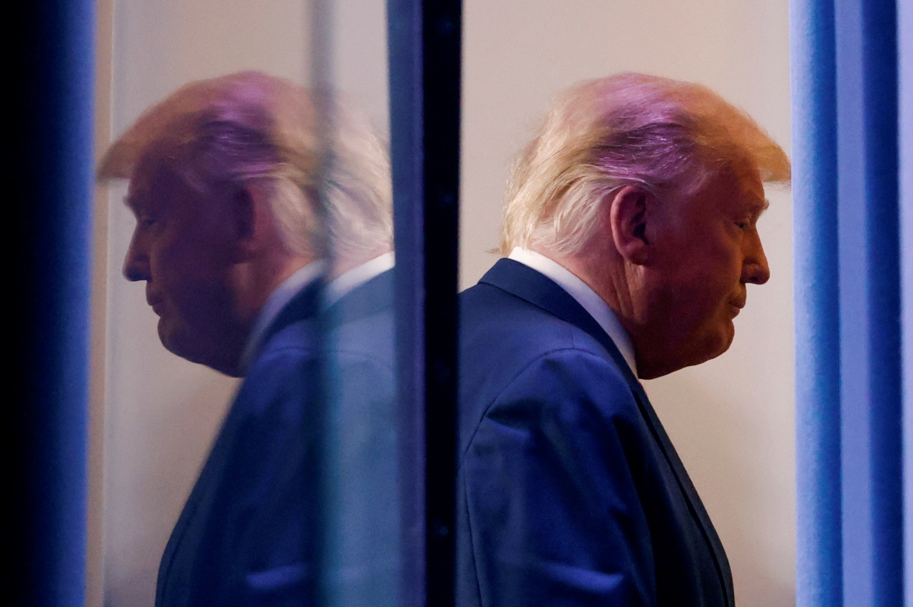 US President Donald Trump is reflected as he departs after speaking about the 2020 US presidential election results in the Brady Press Briefing Room at the White House in Washington, US, Thursday. (Reuters-Yonhap)
