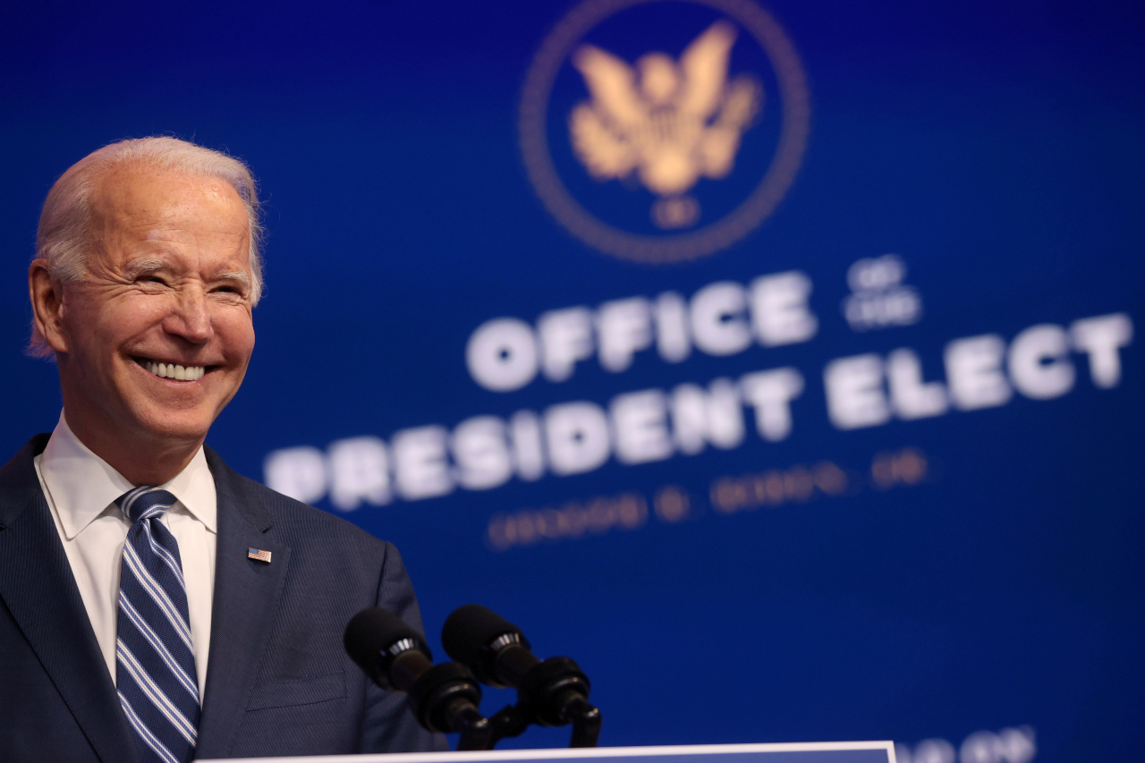 US President-elect Joe Biden smiles as he speaks about health care and the Affordable Care Act (Obamacare) at the theater serving as his transition headquarters in Wilmington, Delaware on Tuesday. (Reuters-Yonhap)