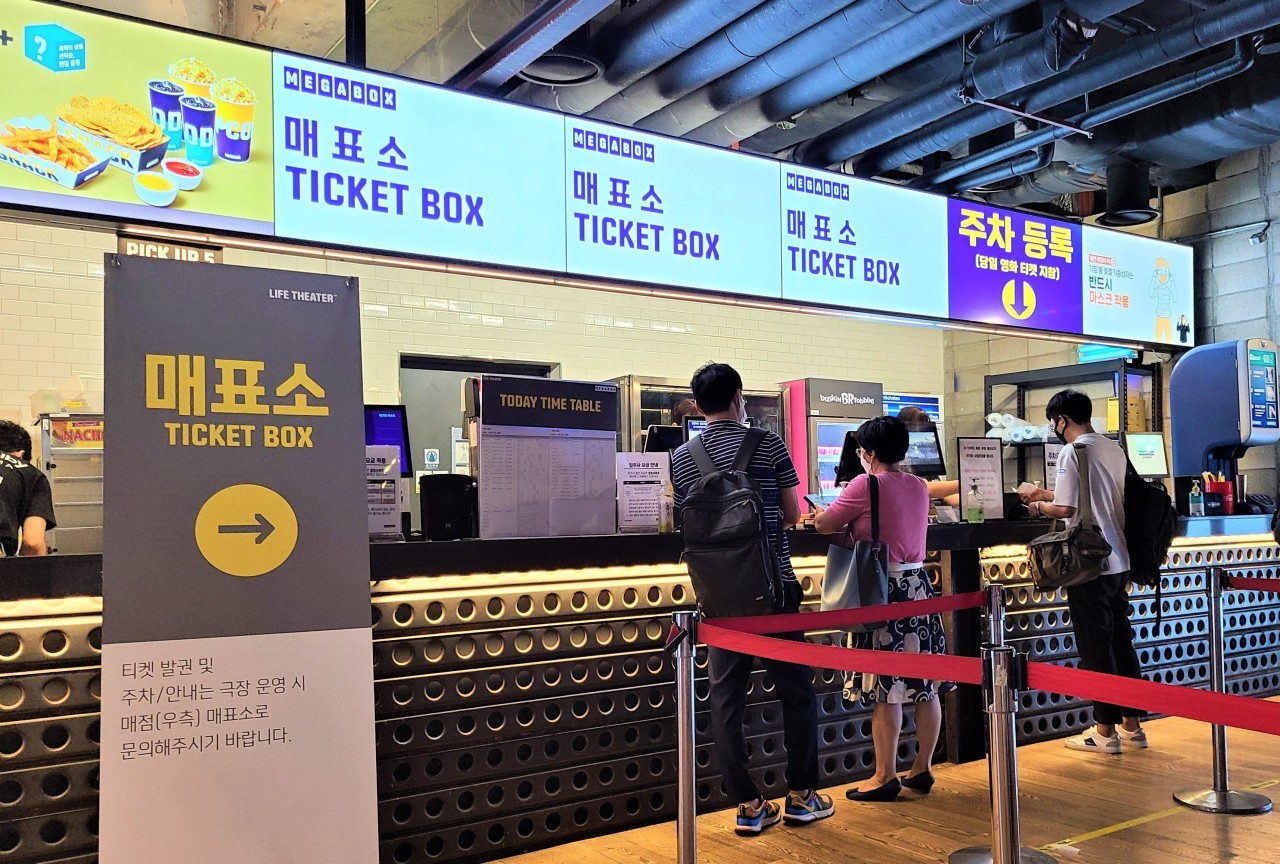 People wait in front of the ticket box at the Megabox Coex branch in Seoul on Monday. (Choi Ji-won/The Korea Herald)