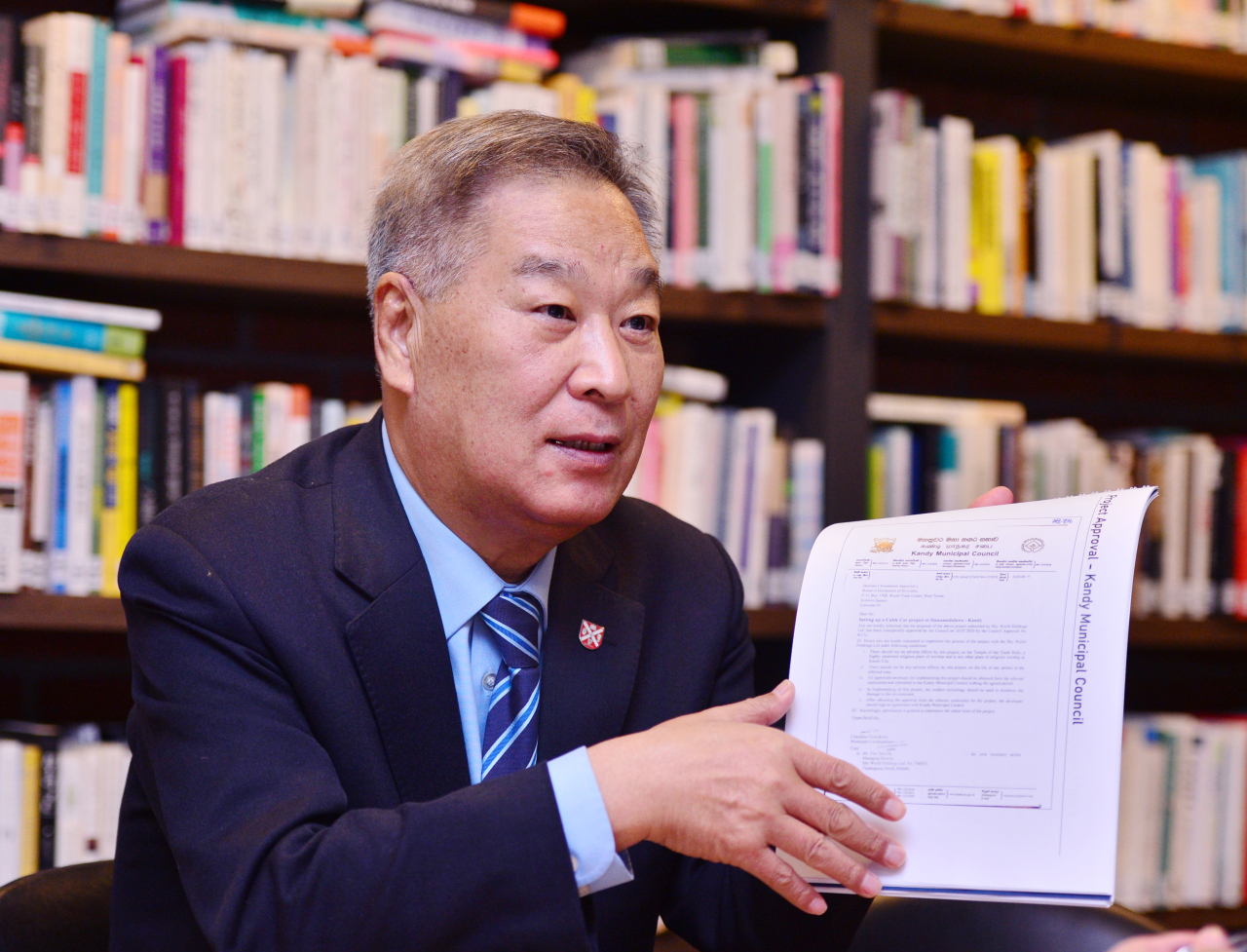 Sky Asia Chairman Yoo Sun-ha shows Kandy cable car project approval document in an interview with The Korea Herald in Seoul on Friday. (Park Hyun-koo/ The Korea Herald)