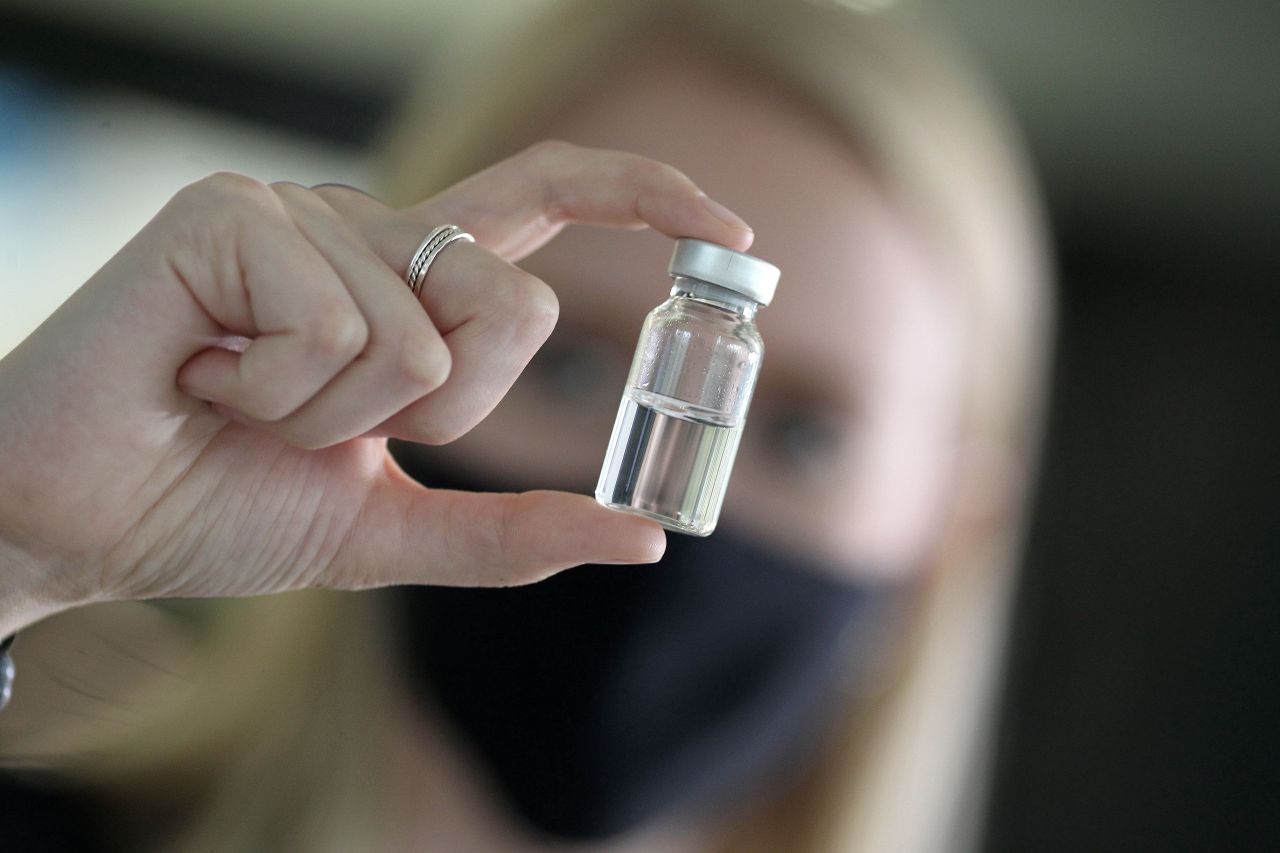 A woman holds a pharmaceutical vial of German glass company Schott at the company's headquarters in Mainz, western Germany, on Friday. (AFP-Yonhap)