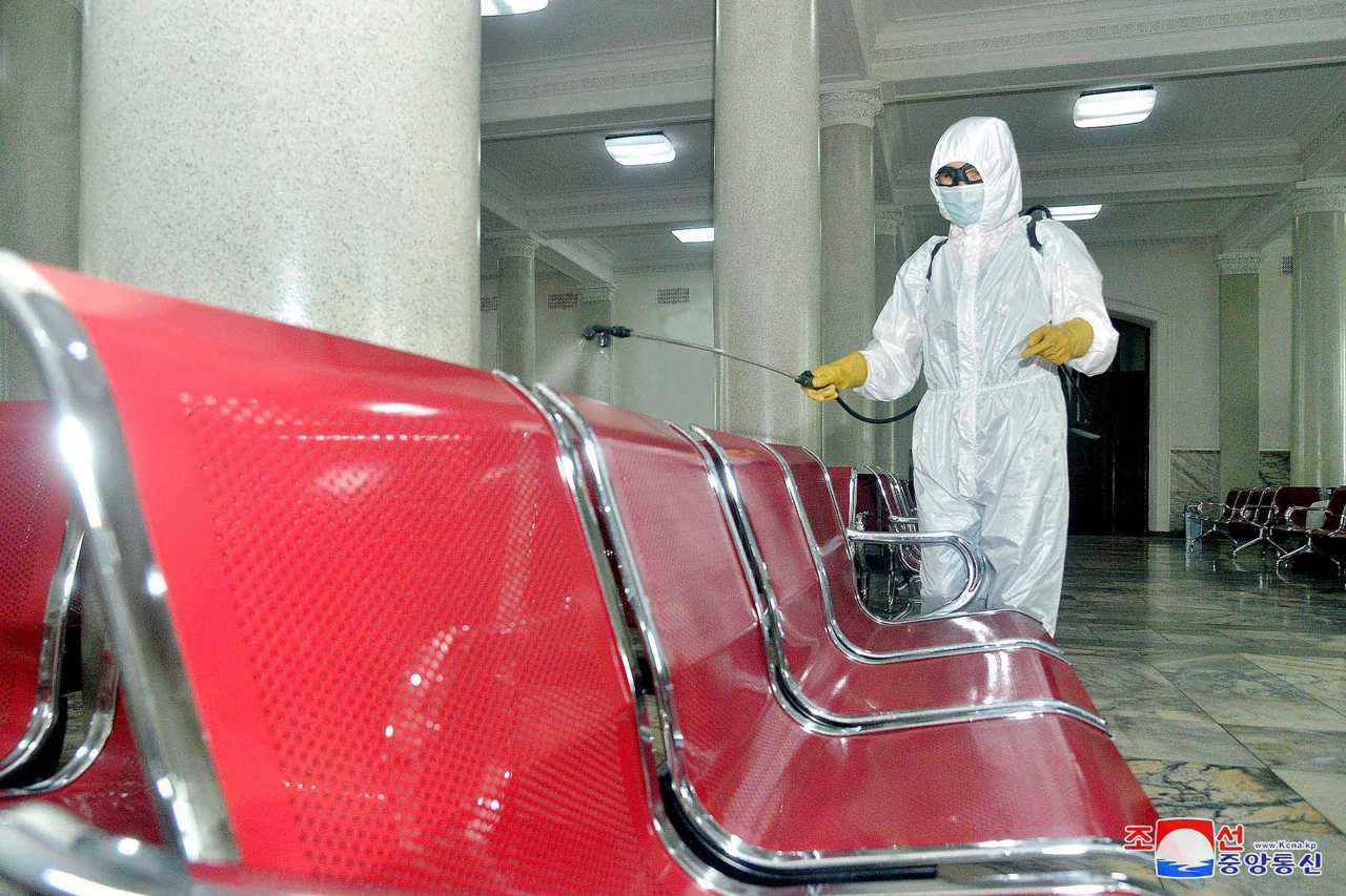 A health worker sanitizing Pyongyang Station in the capital to prevent the outbreak of the coronavirus. (KCNA-Yonhap)