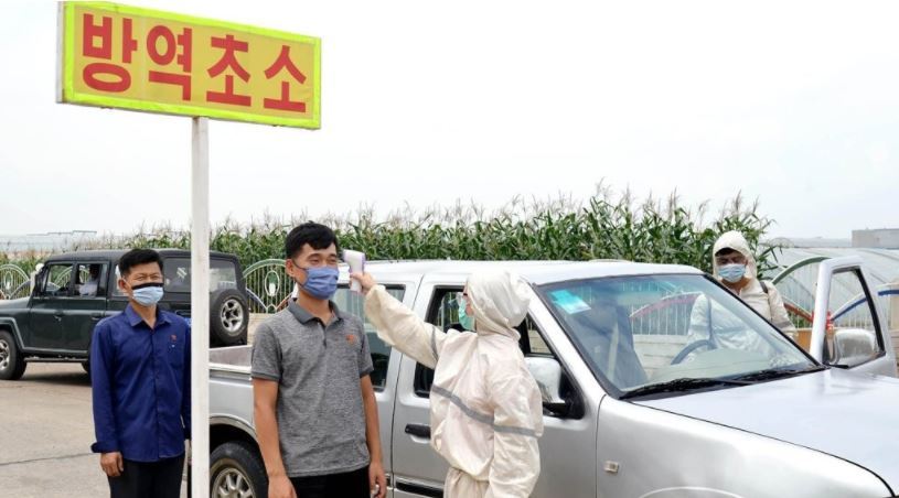 Temperature checks are carried out on people in Pyongyang amid the coronavirus pandemic. (KCNA-Yonhap)