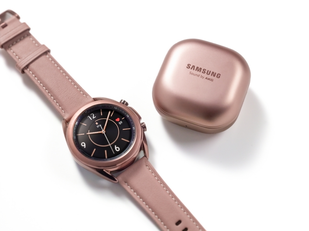 This photo provided by Samsung Electronics Co. shows the company's Galaxy Watch3 smartwatch and the case of Galaxy Buds Live wireless earbuds. (Samsung Electronics Co.)