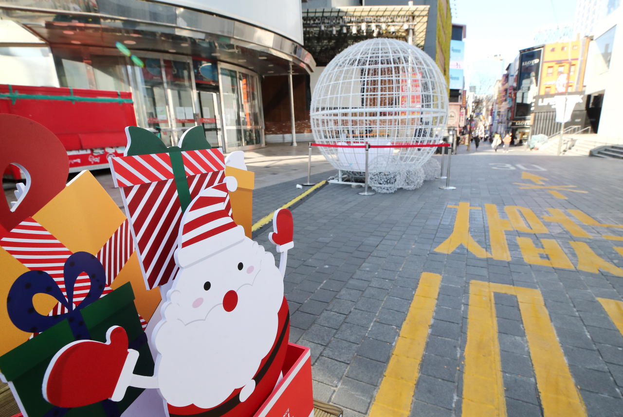 Myeong-dong, a popular tourist district in Seoul, appears empty on Sunday amid a record rise in COVID-19 cases. (Yonhap)