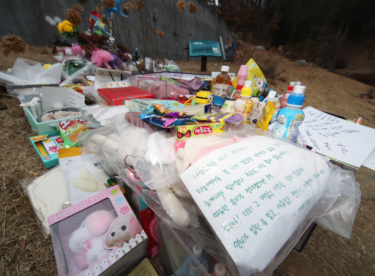 Flowers, gifts and letters on Tuesday are placed by the tomb of 16-month-old Jeong-in, whose death stirred a nationwide political movement callings for legislative change to protect children`s rights.