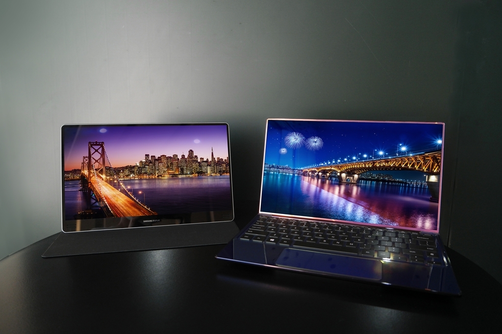 This photo provided by Samsung Display Co. on Thursday, shows laptops using the company's 90Hz OLED screen. (Samsung Display)