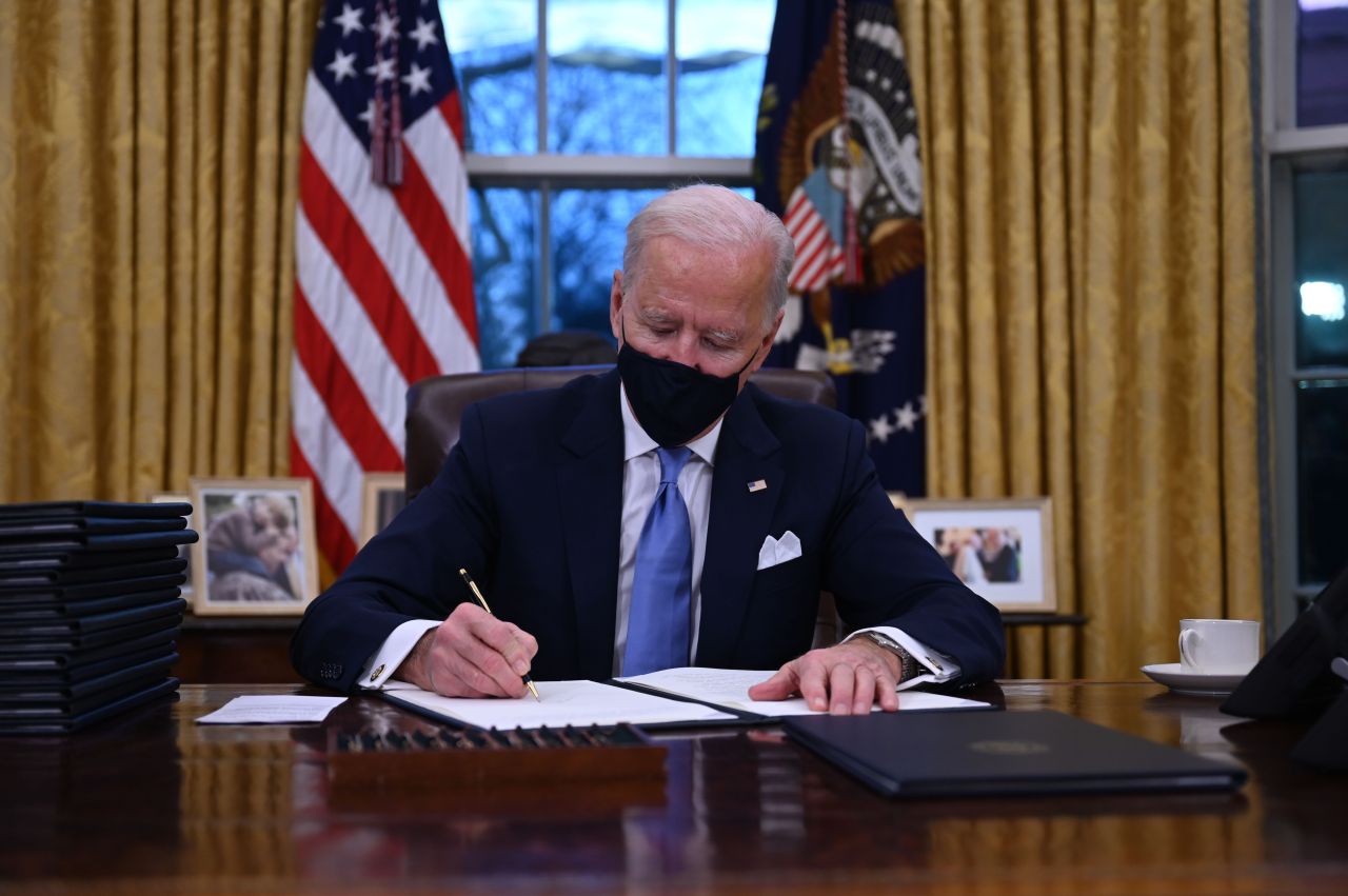 US President Joe Biden sits in the Oval Office as he signs a series of orders at the White House in Washington, after being sworn in at the US Capitol on Wednesday. (AFP-Yonhap)