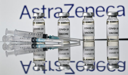 An illustration picture shows vials with Covid-19 Vaccine stickers attached and syringes with the logo of British pharmaceutical company AstraZeneca. (AFP-Yonhap)