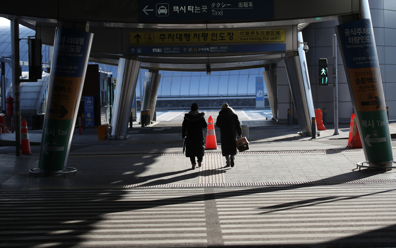 Visitors pass by an empty crosswalk at Incheon International Airport Terminal 1, in January 2021. (Yonhap)